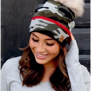Panache camo hat with red stripe and faux pom pom.